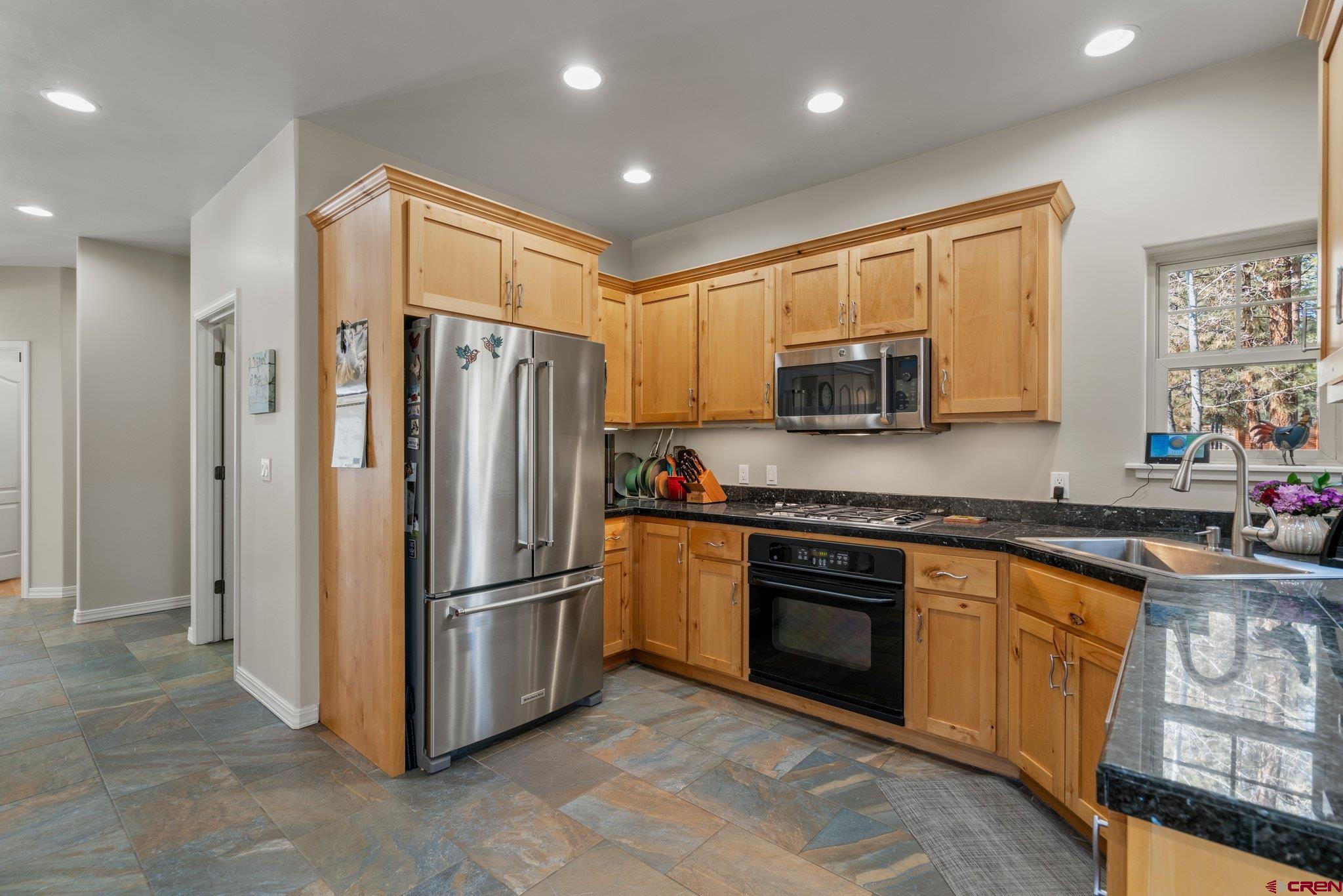 6072 County Road 240 Durango, CO 81301 - Photo 10 of 35 a kitchen with stainless steel appliances granite countertop a refrigerator and a stove top oven
