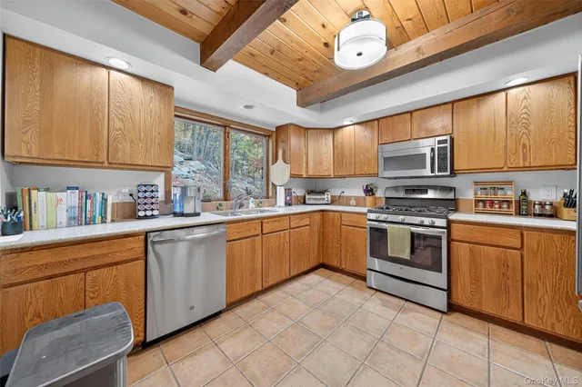 a kitchen with stainless steel appliances granite countertop a stove sink and cabinets