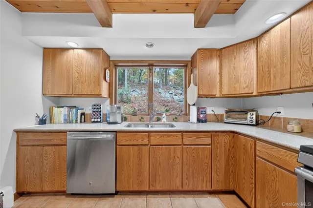 a kitchen with stainless steel appliances granite countertop a sink a stove and cabinets