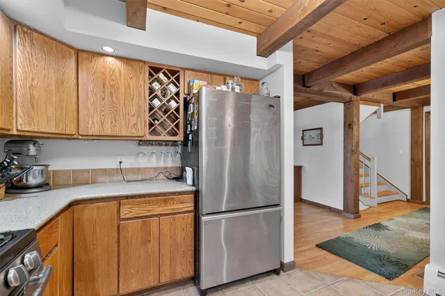 a kitchen with a refrigerator a sink and cabinets
