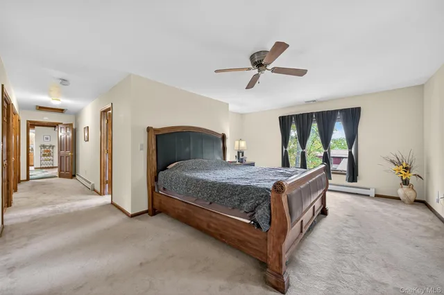 a bedroom with a large bed and a chandelier