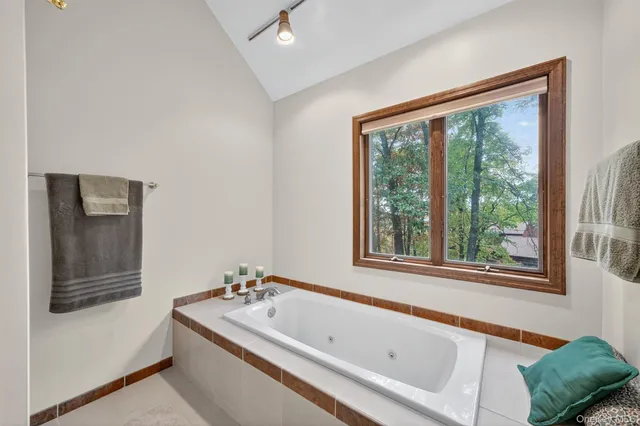 a bathroom with a tub and a window