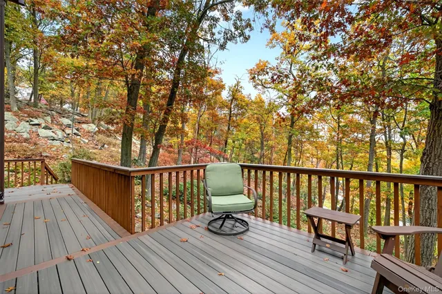a balcony with wooden floor outdoor seating and wooden deck