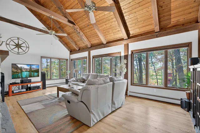 a living room with furniture and large windows