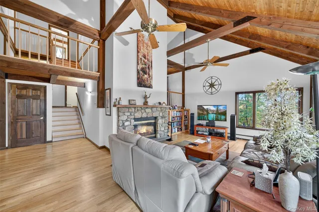 a view of a patio with couches table and chairs with wooden floor
