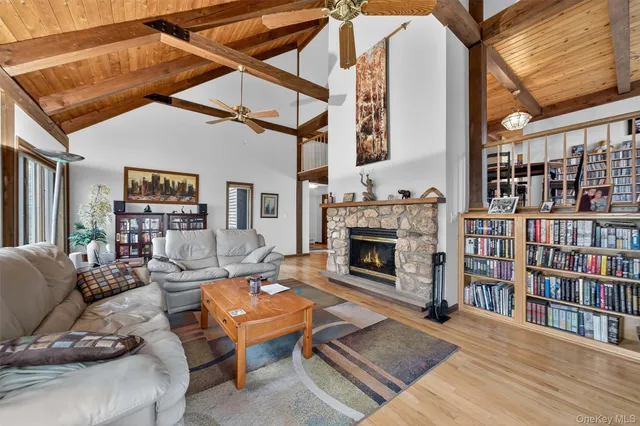 a living room with furniture a fireplace and a book shelf