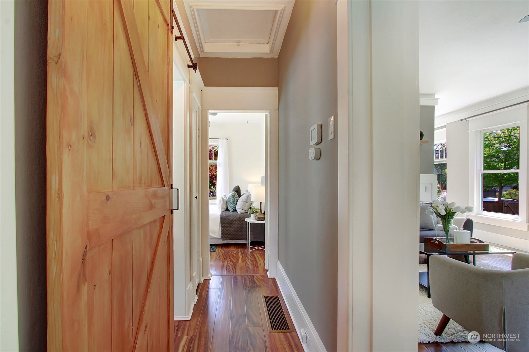 6021 48th Avenue Southwest Seattle, WA 98136 - Photo 15 of 35 a view of a hallway with wooden floor and furniture
