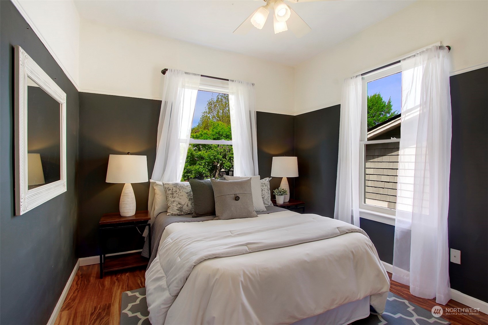 6021 48th Avenue Southwest Seattle, WA 98136 - Photo 16 of 35 a bedroom with a bed lamp and a large window
