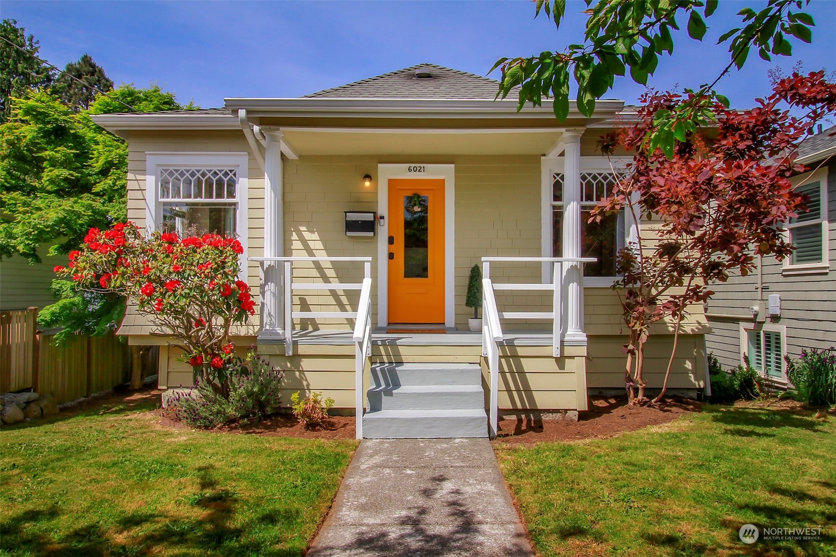 6021 48th Avenue Southwest Seattle, WA 98136 - Photo 2 of 35 a front view of a house with a yard