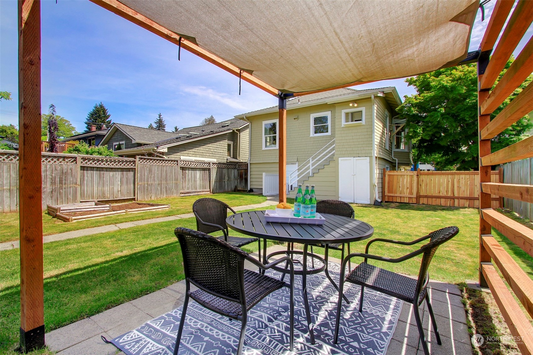 6021 48th Avenue Southwest Seattle, WA 98136 - Photo 23 of 35 a view of a patio with table and chairs with wooden floor and fence