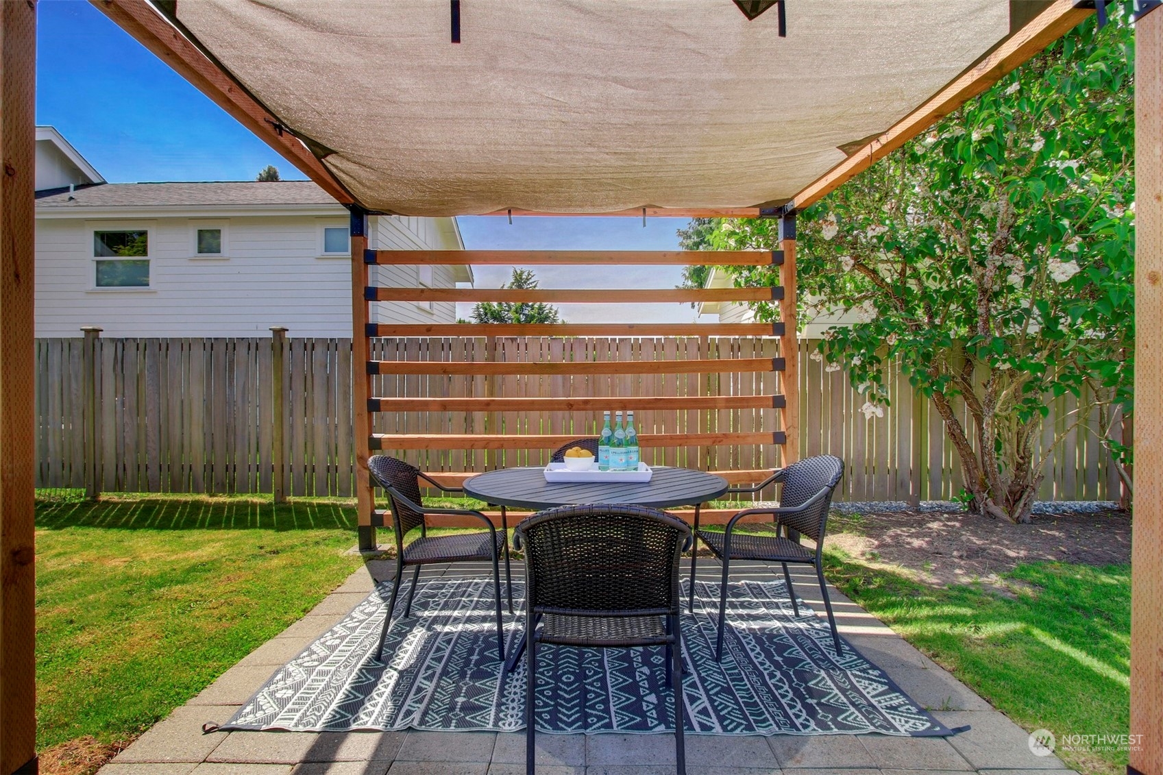 6021 48th Avenue Southwest Seattle, WA 98136 - Photo 24 of 35 a view of a patio with table and chairs with wooden floor and fence
