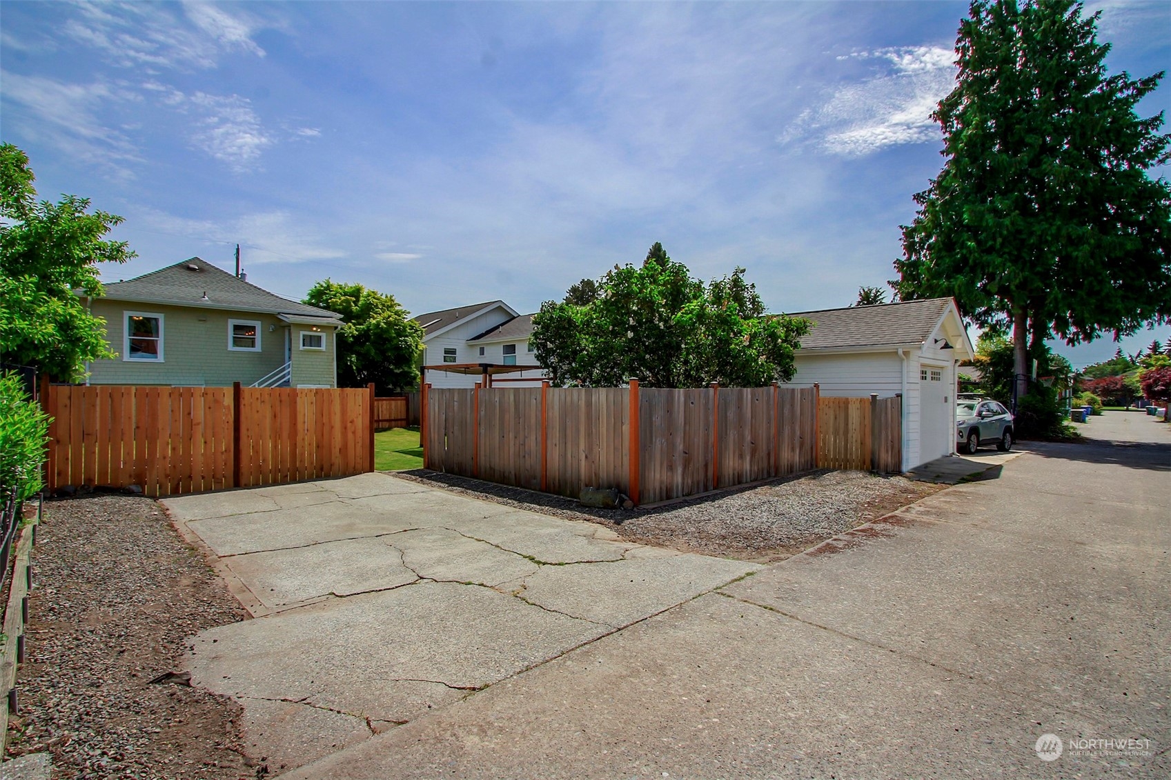 6021 48th Avenue Southwest Seattle, WA 98136 - Photo 27 of 35 a view of backyard with potted plants and wooden fence