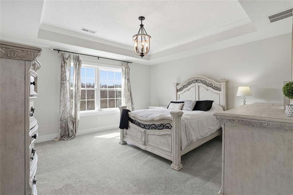 213 Hickory Lane Mars, PA 16046 - Photo 20 of 46 a spacious bedroom with a bed chandelier and a window
