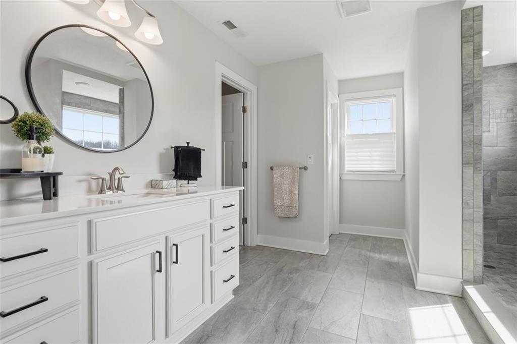213 Hickory Lane Mars, PA 16046 - Photo 22 of 46 a spacious bathroom with a mirror a sink and a mirror