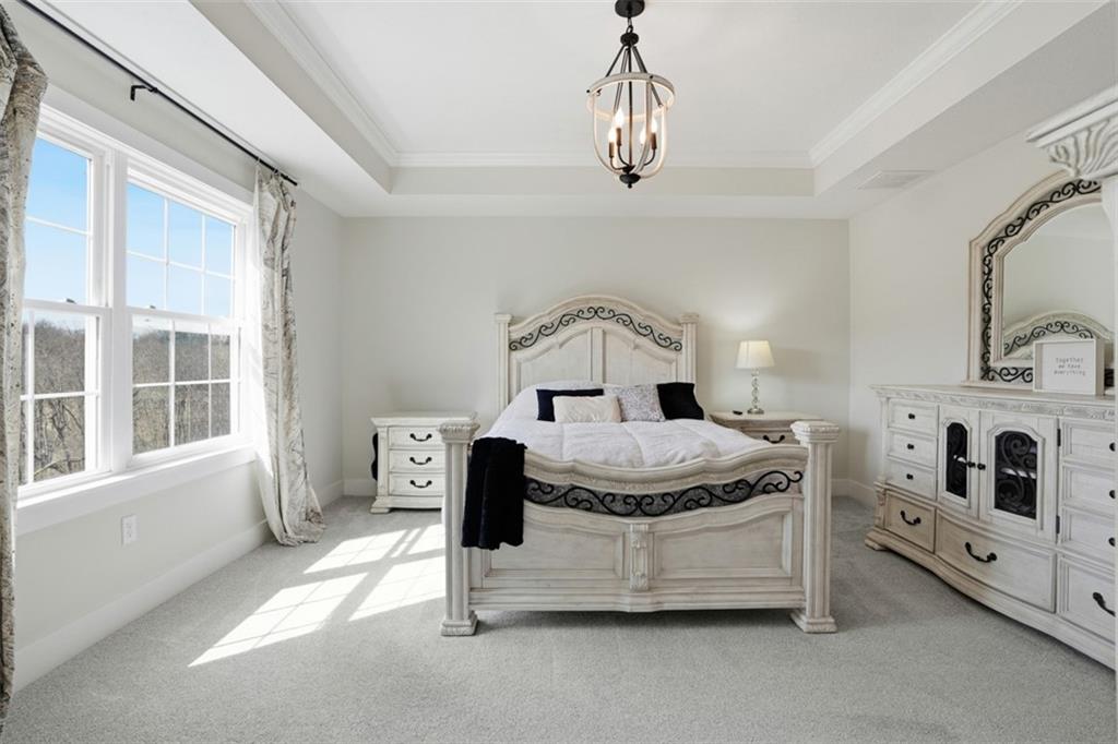 213 Hickory Lane Mars, PA 16046 - Photo 28 of 46 a spacious bedroom with a bed a chandelier and dresser