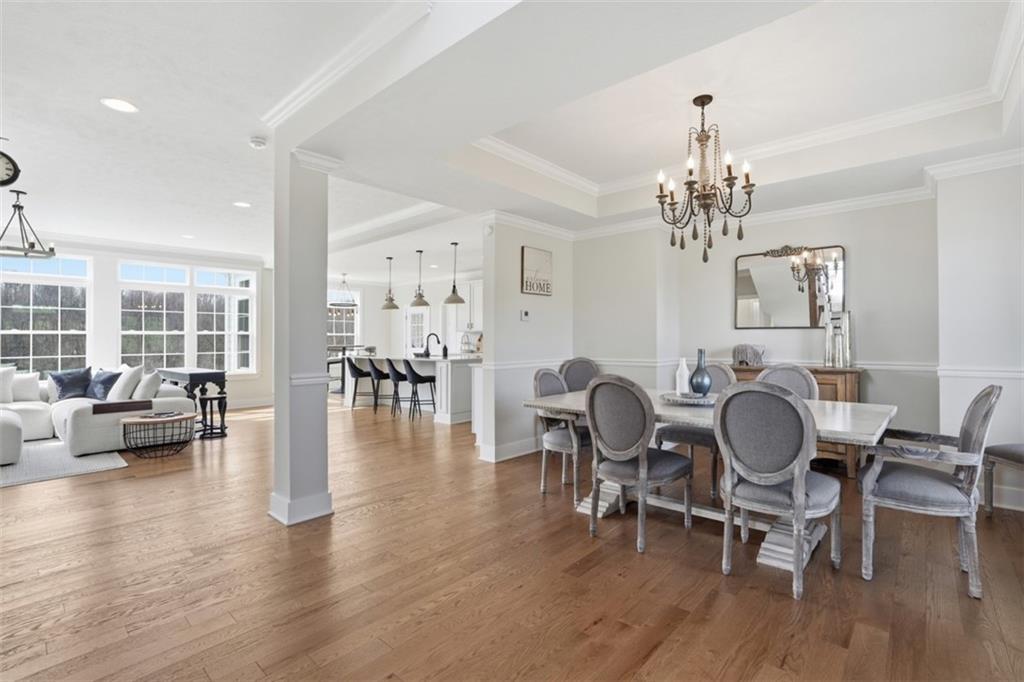213 Hickory Lane Mars, PA 16046 - Photo 7 of 46 a dining room with wooden floor a chandelier a glass table and chairs
