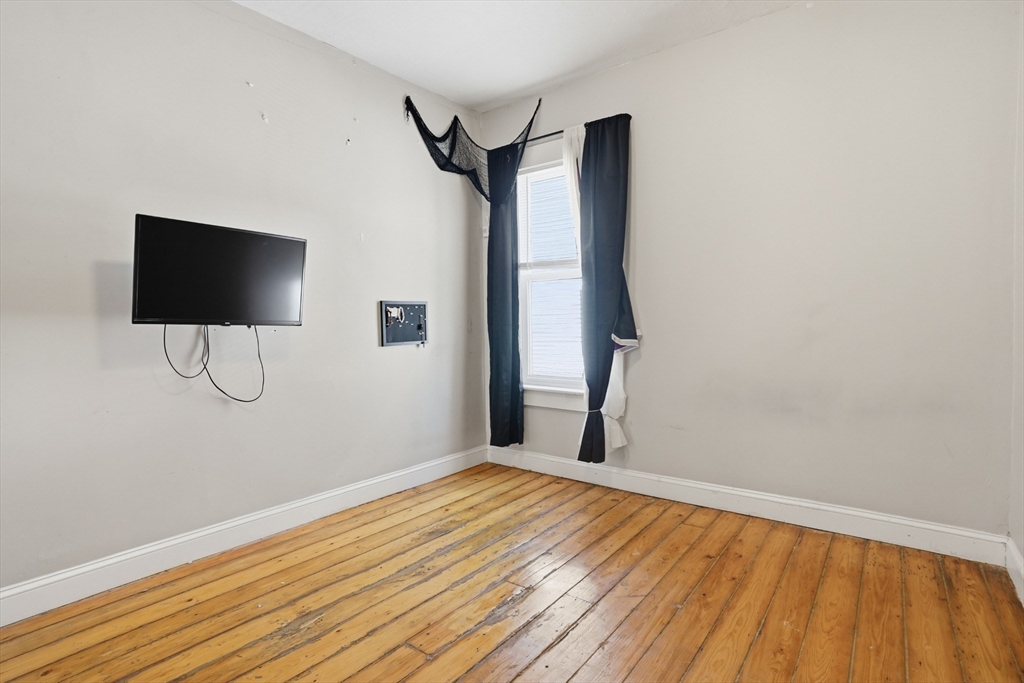 196 Irving Street Fall River, MA 02723 - Photo 16 of 34 a view of a room with wooden floor and a window