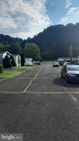 a view of city street with a car parked on the road
