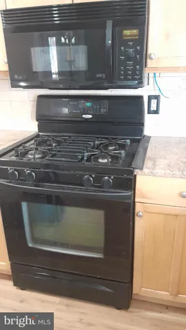 a stove top oven sitting inside of a kitchen