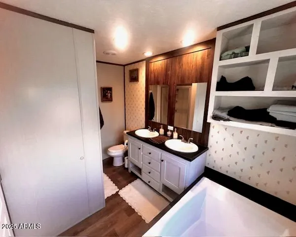 a bathroom with a double vanity sink toilet and shower