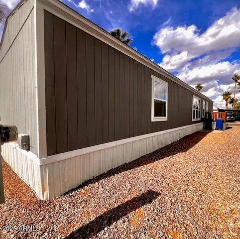 a view of a house with a wooden fence