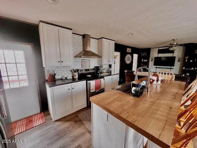 a kitchen that has a lot of cabinets in it and wooden floors