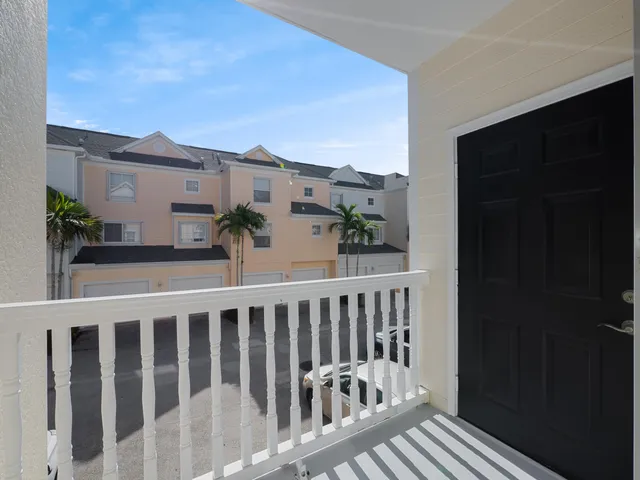 a view of a balcony with wooden fence