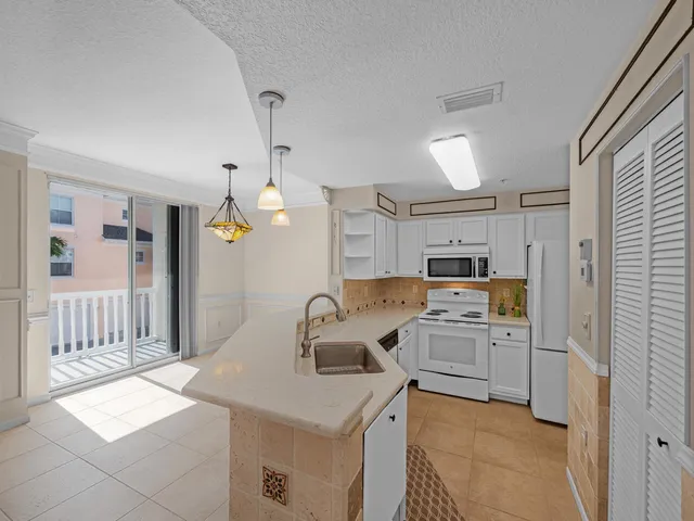 a kitchen that has a sink and a stove