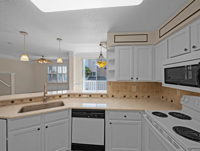 a kitchen with a sink stove and cabinets