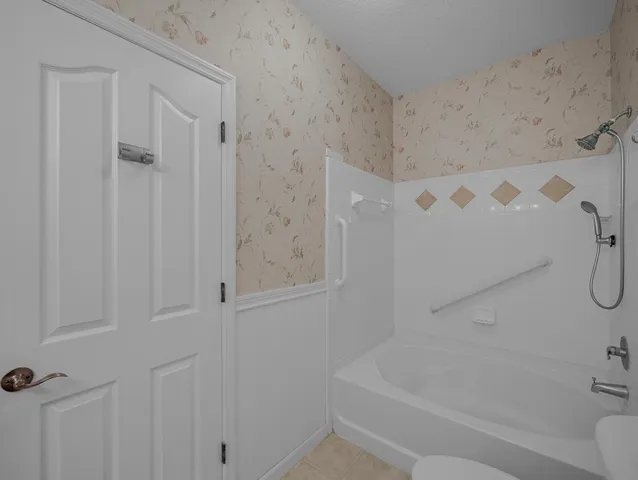 a bathroom with a bathtub and shower