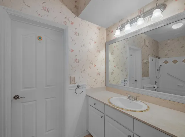 a bathroom with a granite countertop sink mirror and double