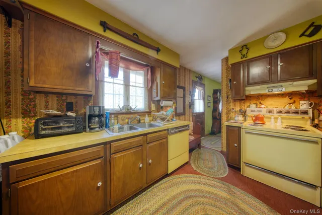 a kitchen with sink cabinets and appliances