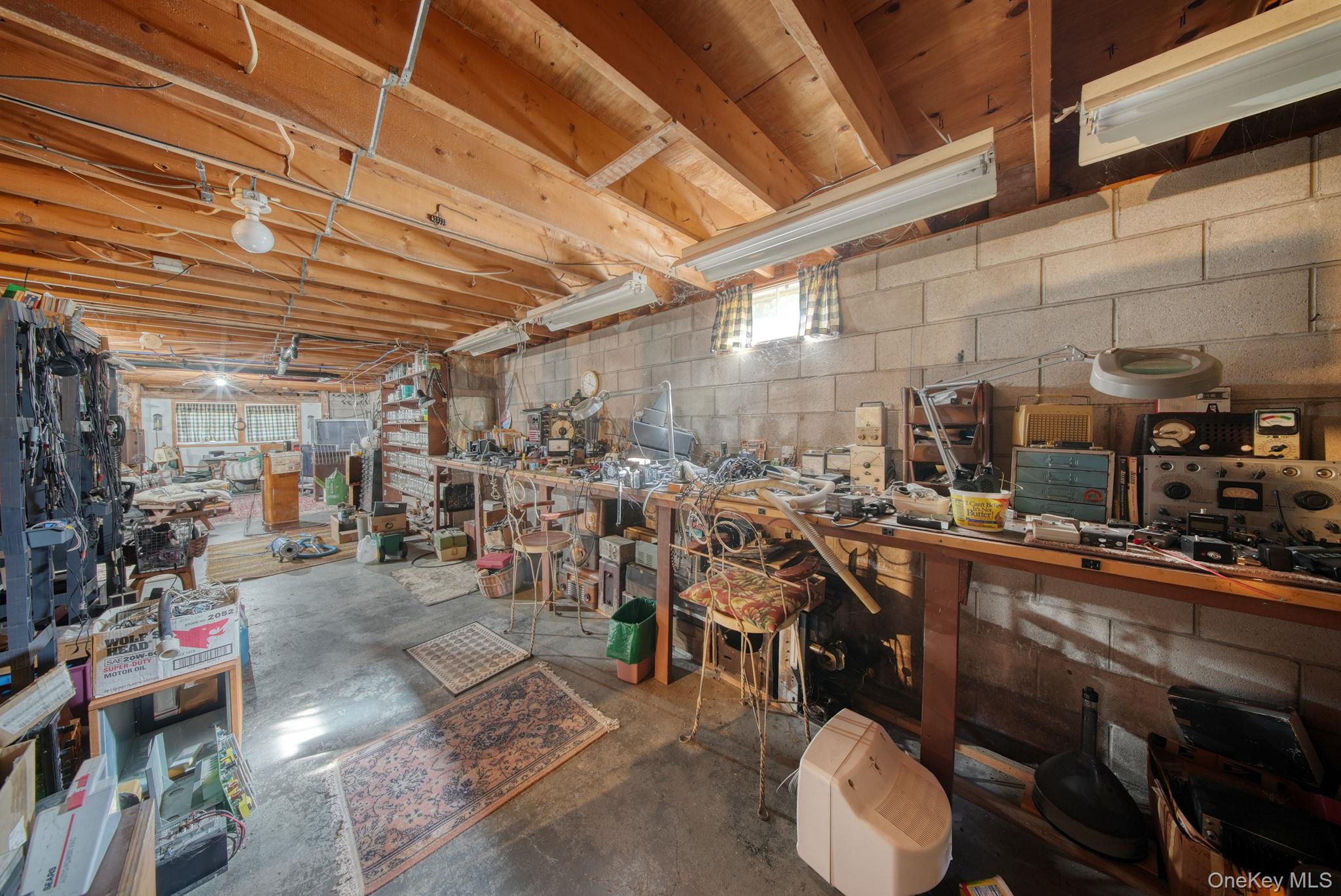 128 Hall Road Grahamsville, NY 12740 - Photo 23 of 34 Miscellaneous room featuring unfinished concrete floors and a workshop area
