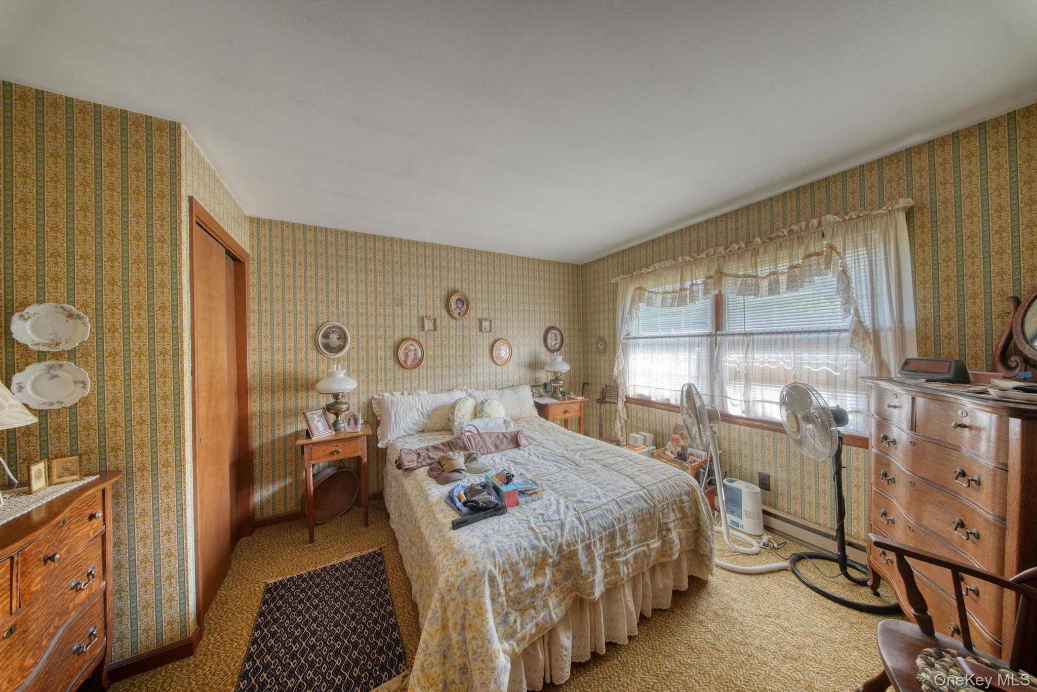 128 Hall Road Grahamsville, NY 12740 - Photo 23 of 34 a bedroom with a bed closet and flat tv screen