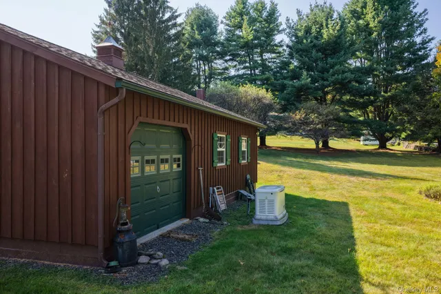 a view of a house with a yard and garage