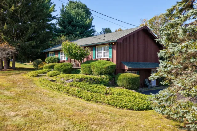 a front view of house with yard and green space