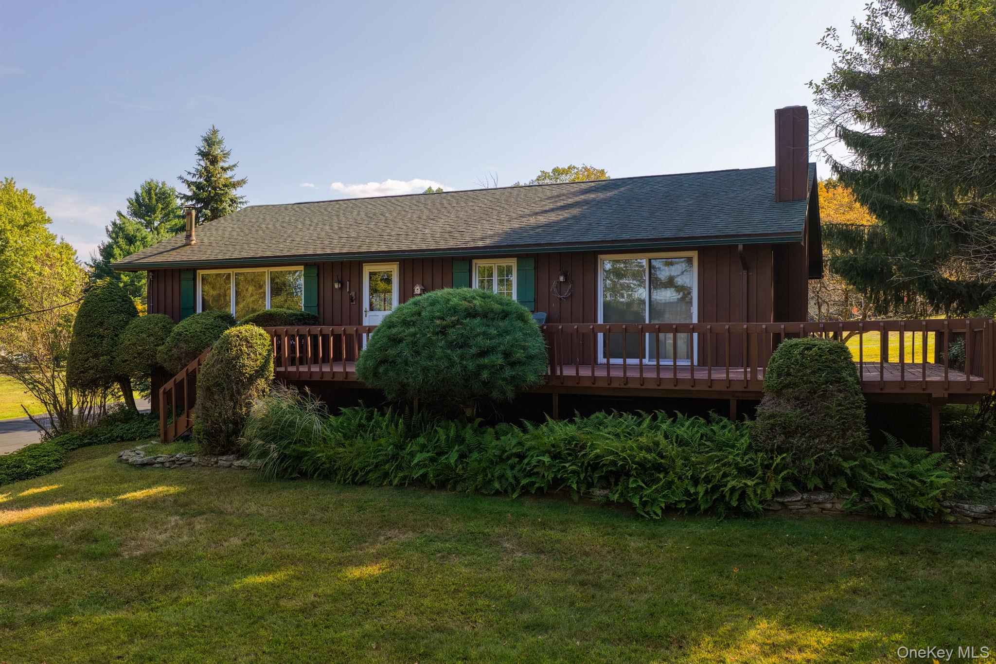 128 Hall Road Grahamsville, NY 12740 - Photo 5 of 34 View of front of home with a chimney, a front lawn, roof with shingles, a deck, and board and batten siding