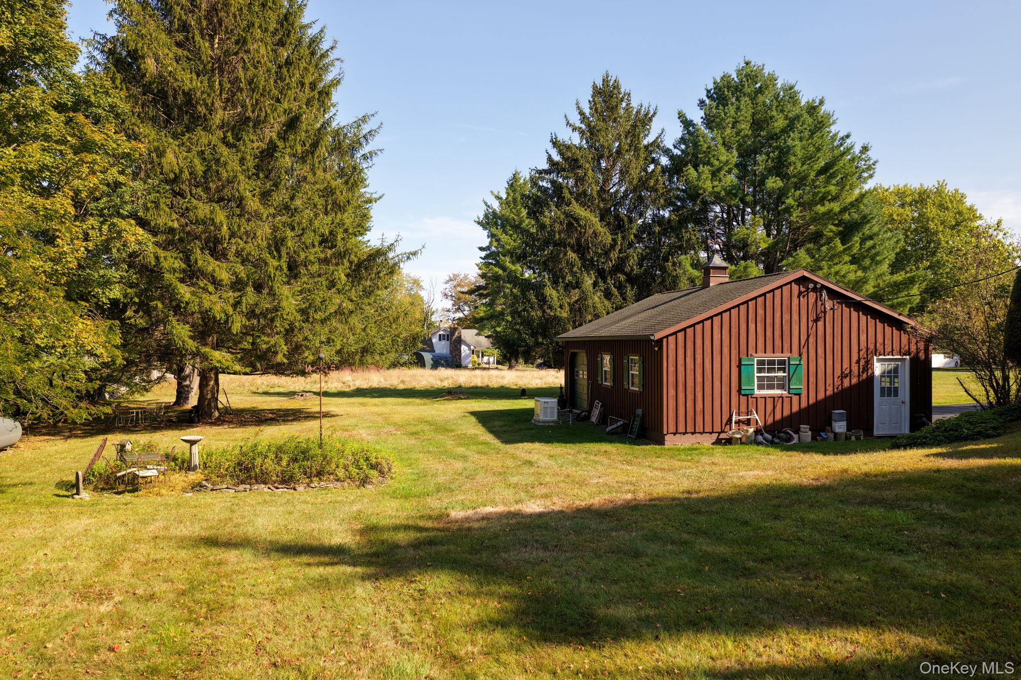 128 Hall Road Grahamsville, NY 12740 - Photo 8 of 34 View of green lawn featuring view of wooded area