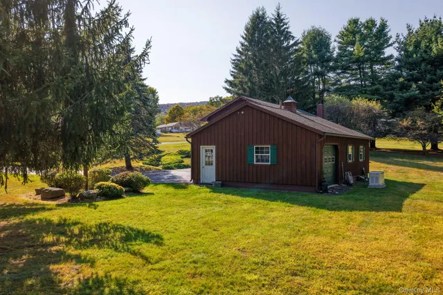 a house view with swimming pool in front of it