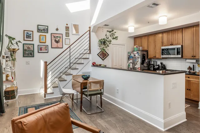 a kitchen with stainless steel appliances kitchen island granite countertop a refrigerator and a stove top oven