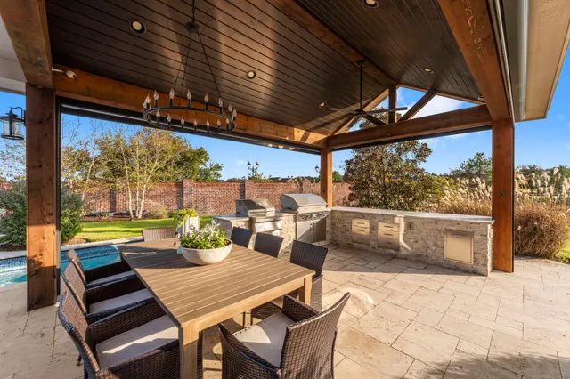 a outdoor space with lots of tables a large window and chairs
