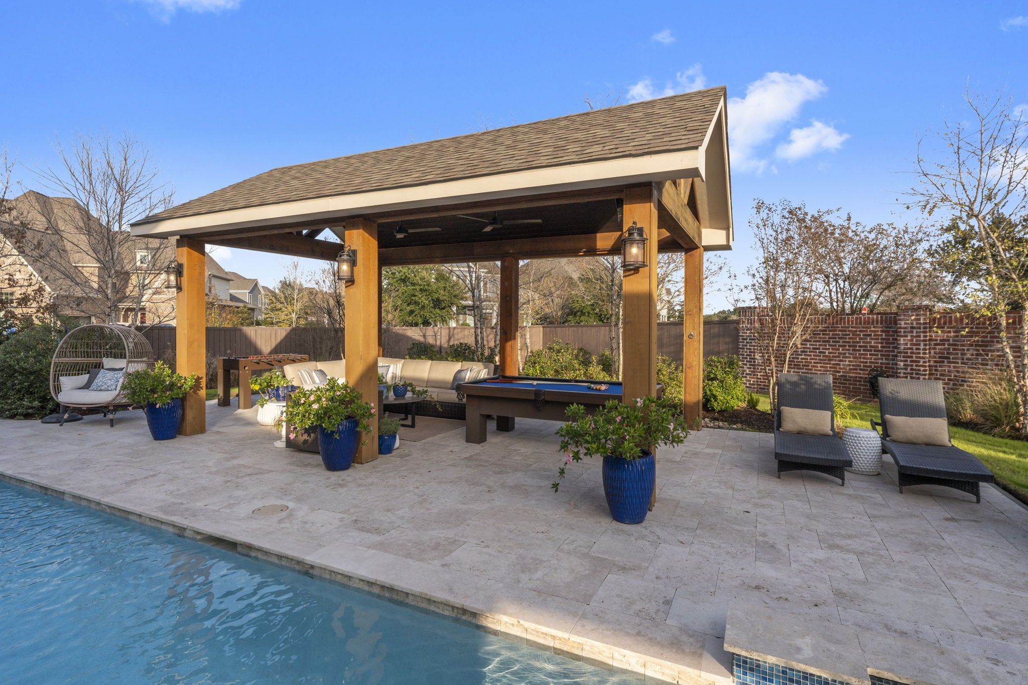2203 Flameleaf Court Conroe, TX 77384 - Photo 41 of 49 a backyard of a house with barbeque oven table and chairs