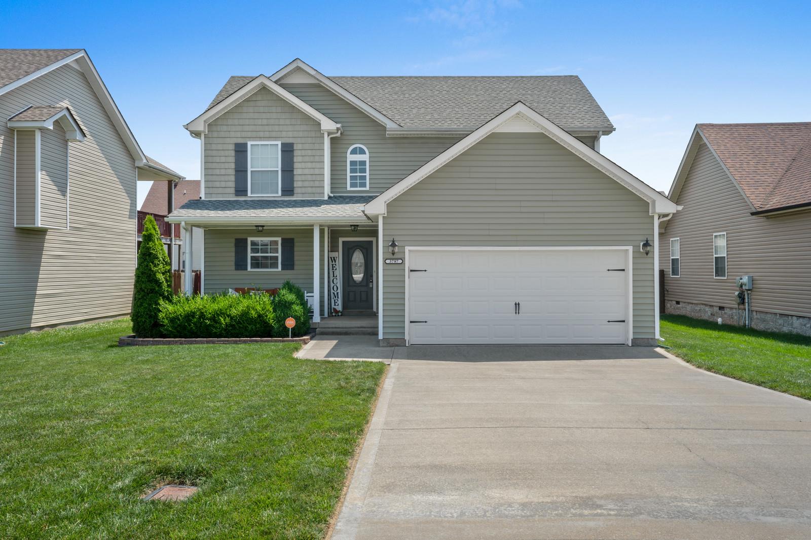 3787 Suiter Road Clarksville, TN 37040 - Photo 1 of 23 a front view of a house with a yard and garage