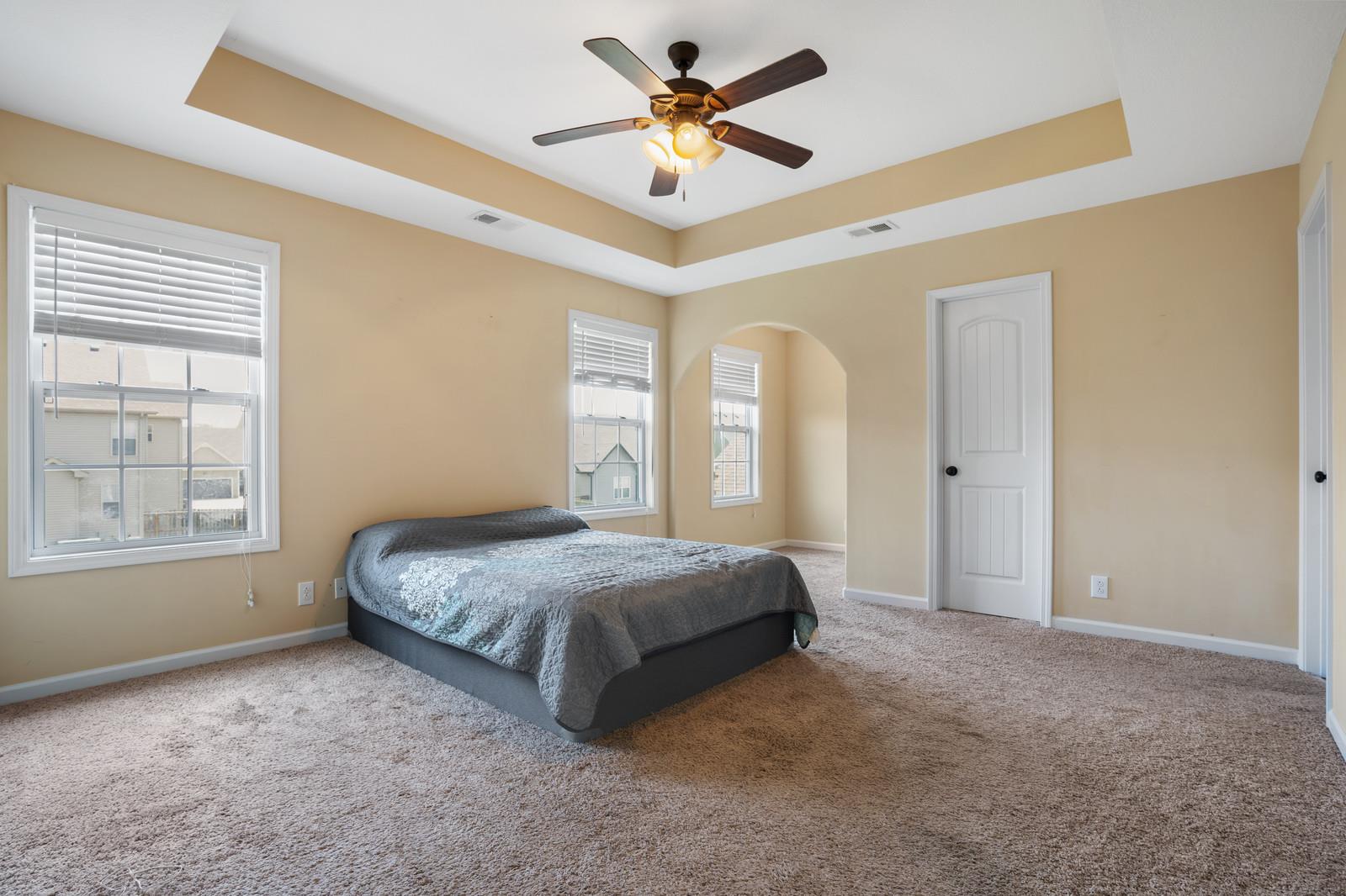 3787 Suiter Road Clarksville, TN 37040 - Photo 13 of 23 a spacious bedroom with a bed and a chandelier