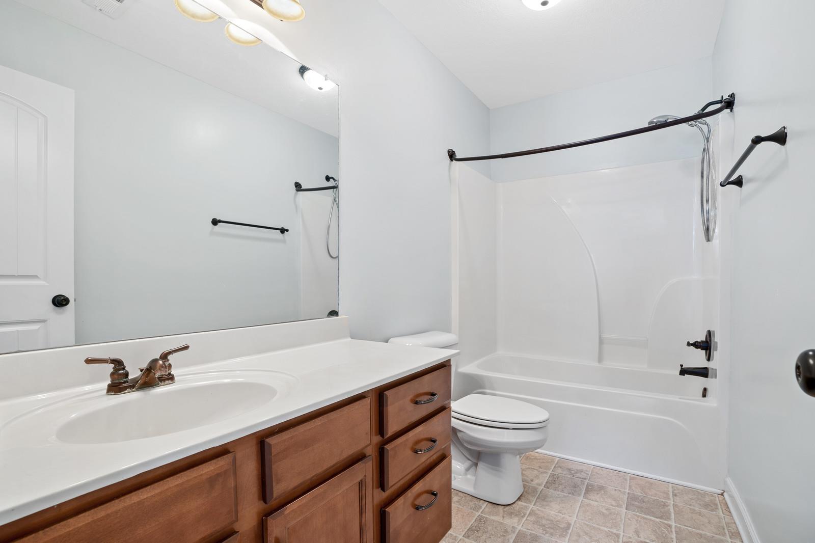 3787 Suiter Road Clarksville, TN 37040 - Photo 17 of 23 a bathroom with a sink toilet tub and shower