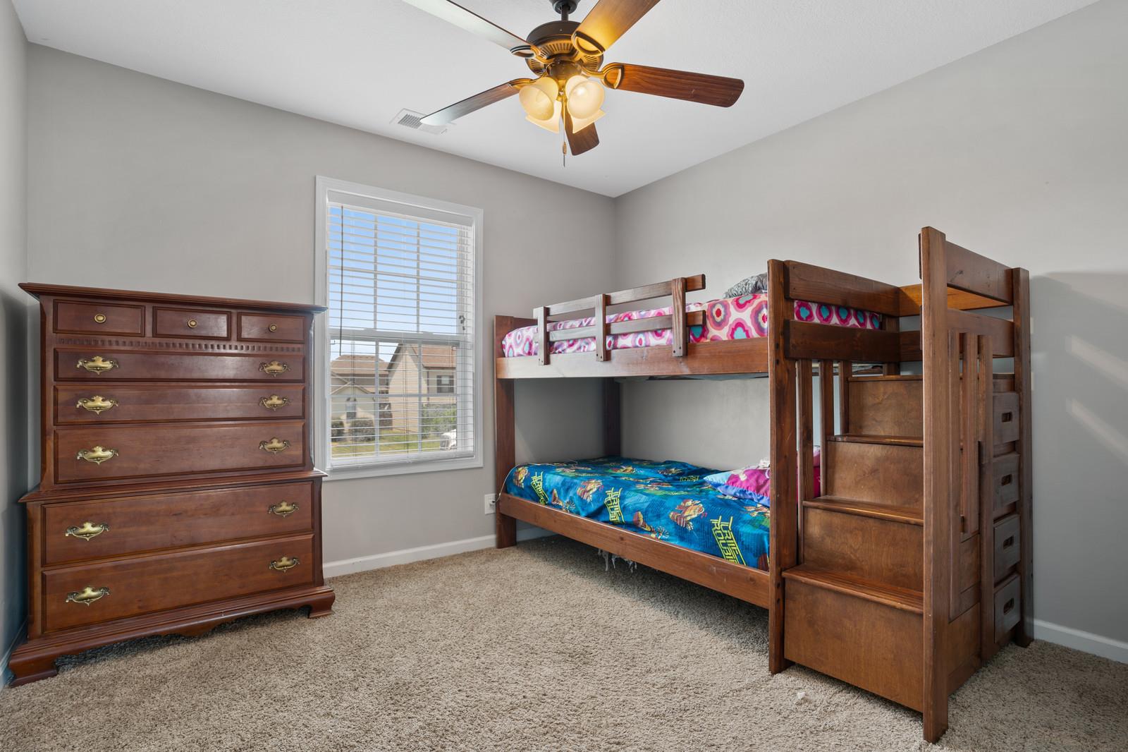 3787 Suiter Road Clarksville, TN 37040 - Photo 19 of 23 a bedroom with a baby bed a chandelier and a dresser