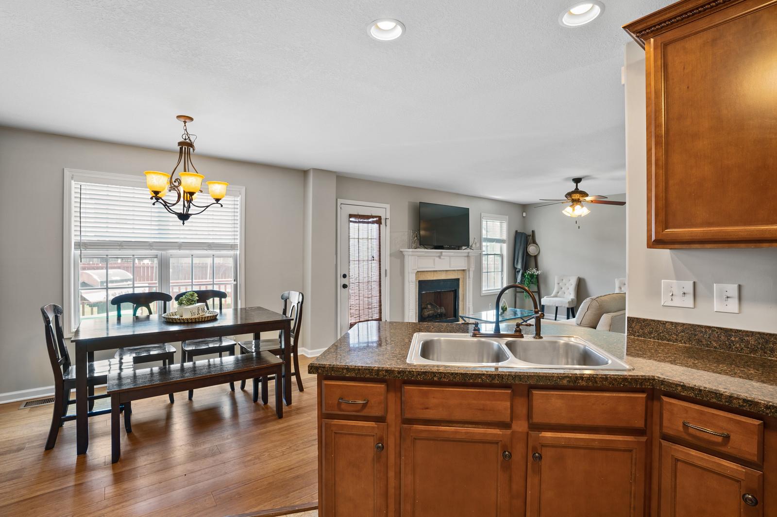 3787 Suiter Road Clarksville, TN 37040 - Photo 9 of 23 a kitchen with a dining table chairs and granite counter tops