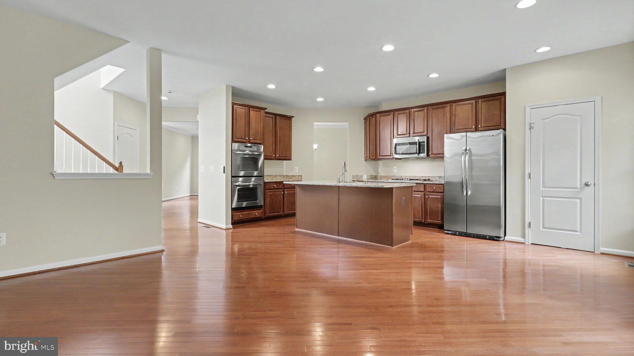 42371 Trellis Square Brambleton, VA 20148 - Photo 26 of 70 Modern kitchen with warm wood tones.