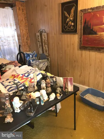 a bedroom with a bed and wall painting on the wall