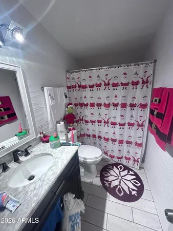 a bathroom with a sink toilet and mirror